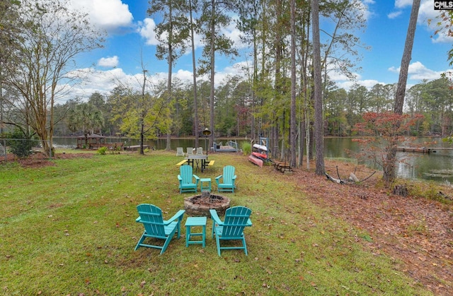 view of yard featuring a water view and an outdoor fire pit