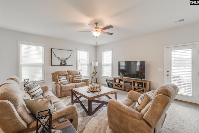 carpeted living room featuring ceiling fan