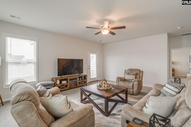 carpeted living room with ceiling fan