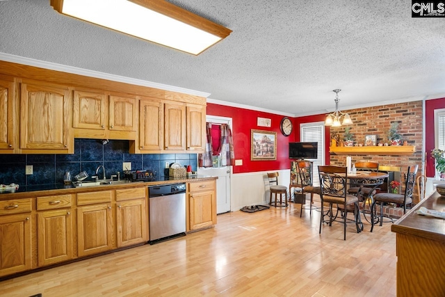 kitchen with ornamental molding, decorative light fixtures, sink, light hardwood / wood-style floors, and dishwasher