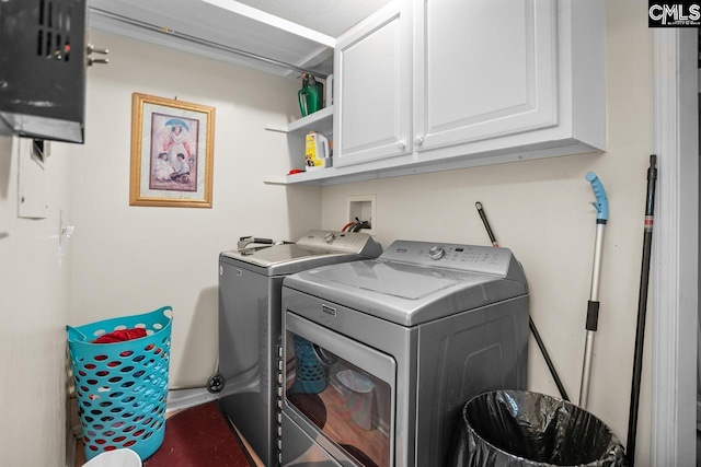 laundry room with cabinets and separate washer and dryer