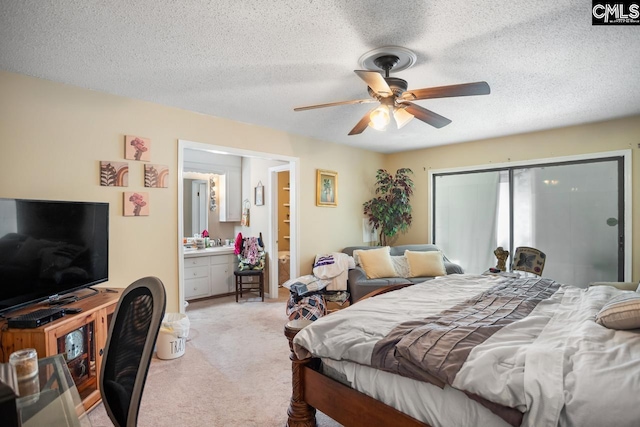 carpeted bedroom with connected bathroom, a closet, a textured ceiling, and ceiling fan