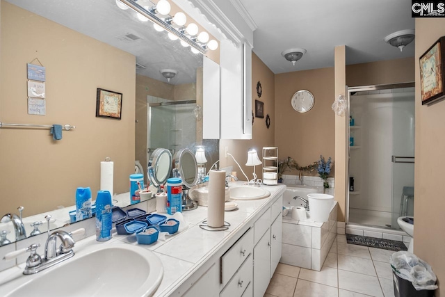 bathroom featuring shower with separate bathtub, tile patterned floors, and vanity