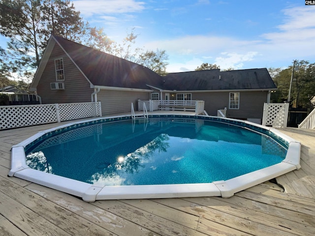 view of swimming pool with a wooden deck