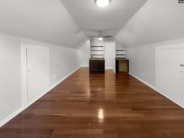 bonus room with lofted ceiling and dark hardwood / wood-style floors