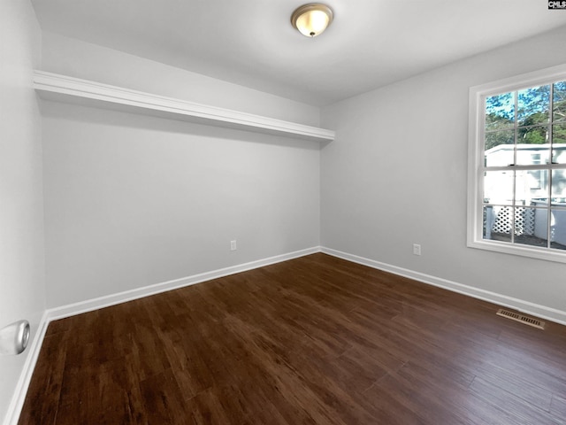 empty room with dark hardwood / wood-style floors