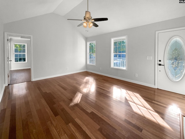 entryway with dark wood-type flooring, a healthy amount of sunlight, and lofted ceiling