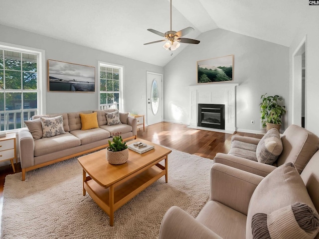 living room featuring ceiling fan, lofted ceiling, and light hardwood / wood-style floors