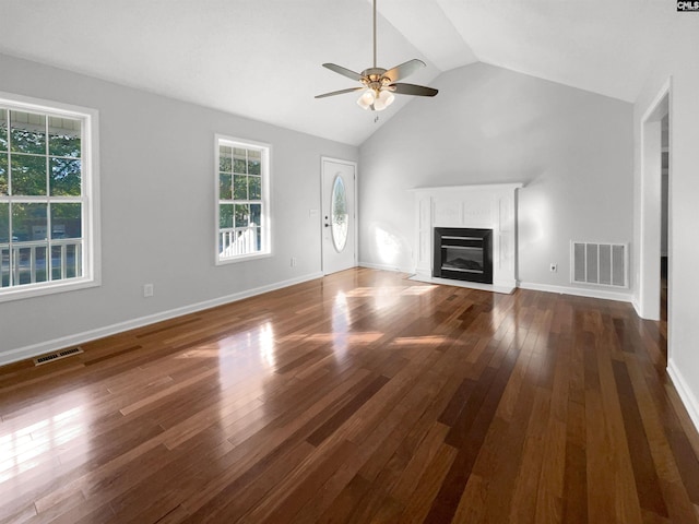 unfurnished living room featuring dark hardwood / wood-style flooring, ceiling fan, and lofted ceiling