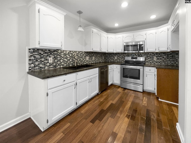 kitchen with stainless steel appliances, dark hardwood / wood-style flooring, sink, tasteful backsplash, and white cabinetry