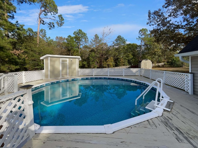 view of pool featuring a deck and a shed