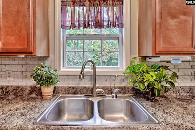 interior details featuring sink and tasteful backsplash