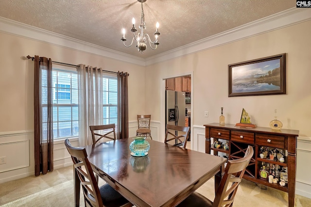 carpeted dining space featuring a chandelier, a textured ceiling, and ornamental molding