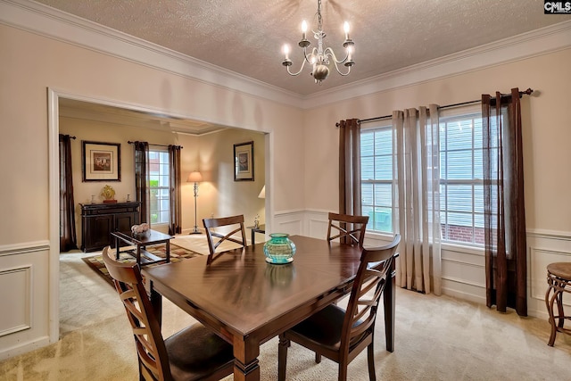 carpeted dining area featuring ornamental molding, a chandelier, a textured ceiling, and a healthy amount of sunlight