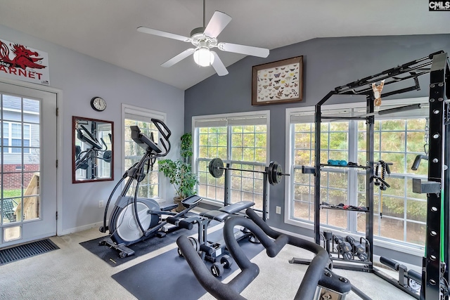 workout area featuring ceiling fan, light carpet, and lofted ceiling