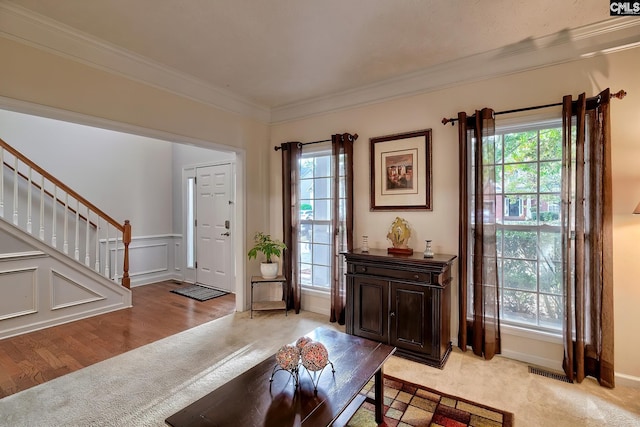 interior space with ornamental molding and light hardwood / wood-style floors