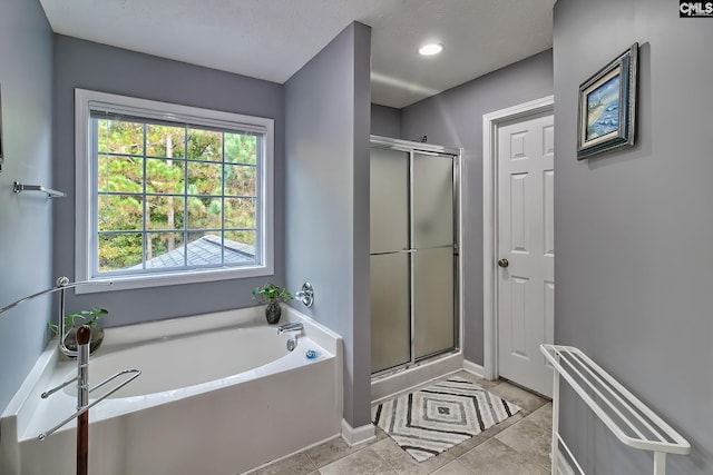 bathroom with independent shower and bath and tile patterned floors