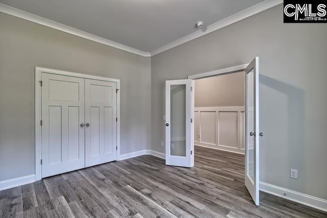 unfurnished bedroom featuring french doors, hardwood / wood-style flooring, and crown molding