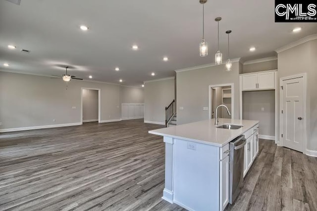 kitchen with stainless steel dishwasher, ceiling fan, sink, a center island with sink, and white cabinets