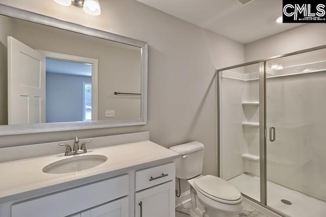 bathroom featuring vanity, toilet, and walk in shower