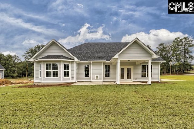 back of house with a lawn and a patio area