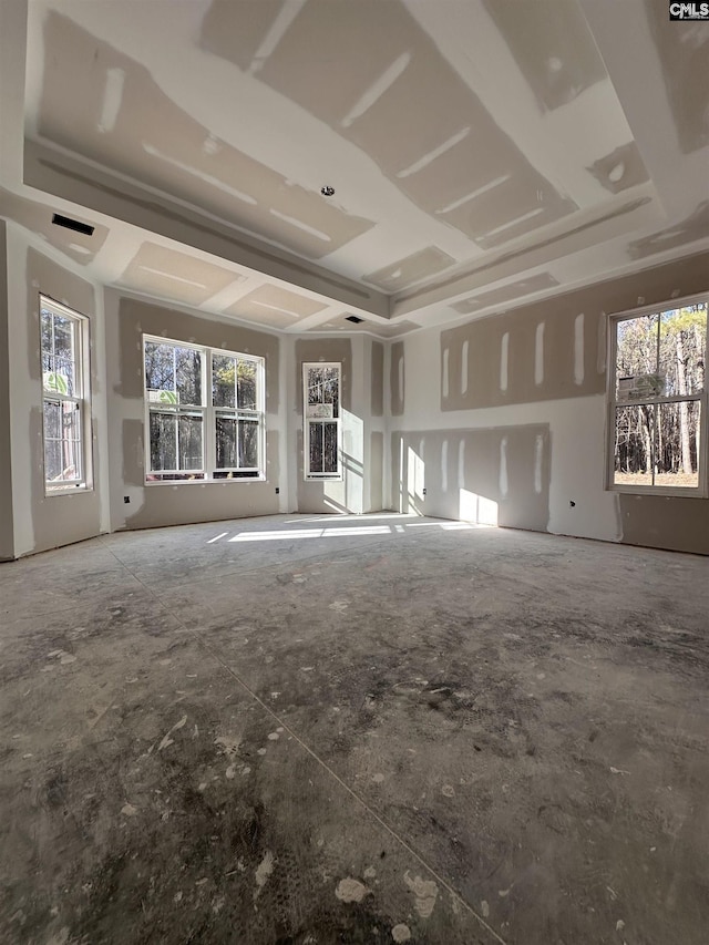 unfurnished living room featuring a tray ceiling