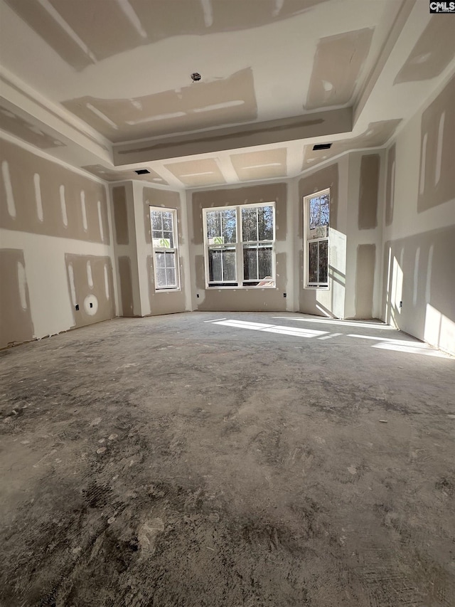 unfurnished living room featuring a raised ceiling