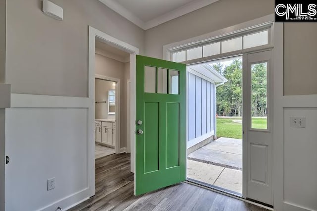 doorway to outside featuring hardwood / wood-style floors and ornamental molding