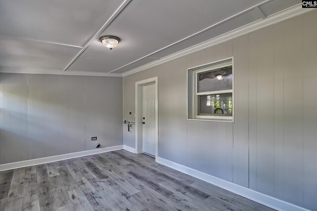 laundry area with hardwood / wood-style floors, wood walls, and crown molding