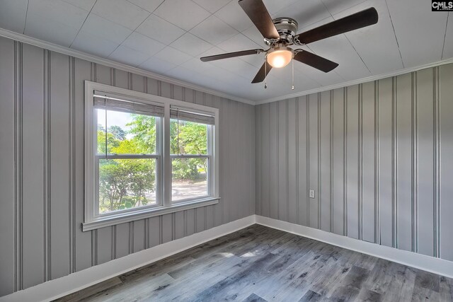 spare room with ceiling fan, wood-type flooring, and ornamental molding