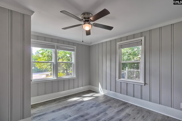 empty room with light hardwood / wood-style floors, ceiling fan, and crown molding