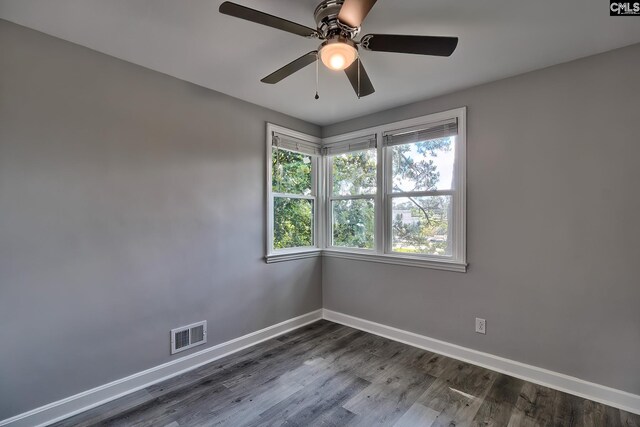 unfurnished room featuring dark hardwood / wood-style floors and ceiling fan