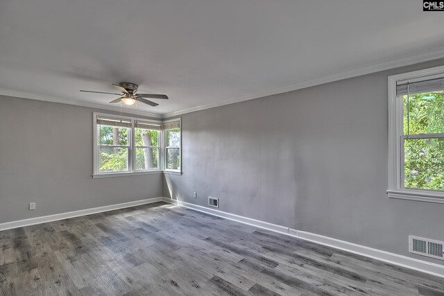 unfurnished room with ornamental molding, hardwood / wood-style floors, and a healthy amount of sunlight