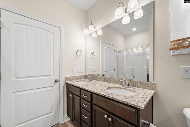 bathroom with vanity and a shower with door