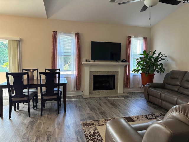 living room with plenty of natural light, hardwood / wood-style flooring, ceiling fan, and vaulted ceiling