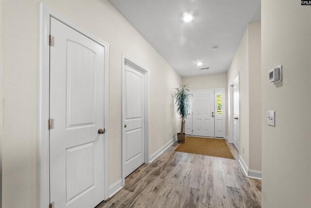 hallway with light hardwood / wood-style flooring