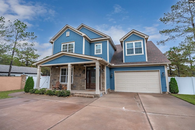 craftsman inspired home with a garage and a porch