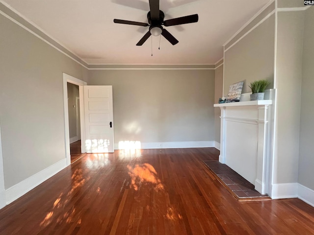 spare room with dark hardwood / wood-style flooring, a tile fireplace, ceiling fan, and crown molding