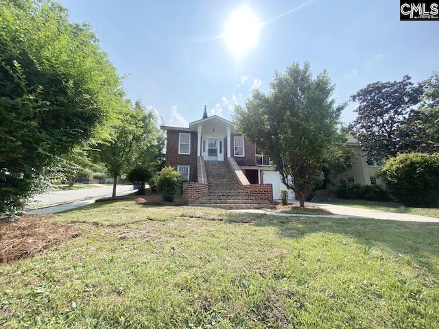 view of front of property with a garage and a front yard