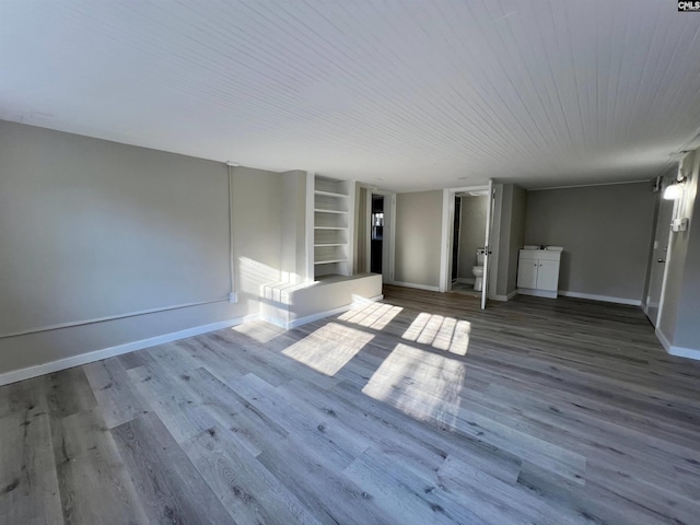 interior space with hardwood / wood-style flooring and built in shelves