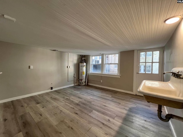 interior space featuring light hardwood / wood-style floors, gas water heater, a healthy amount of sunlight, and wood ceiling