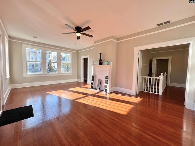 interior space with ornamental molding, wood-type flooring, and ceiling fan