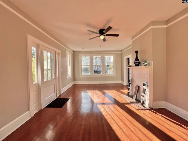 entryway featuring ceiling fan, wood-type flooring, and ornamental molding