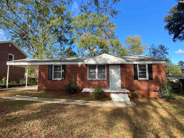 view of front of property with a front yard and a carport