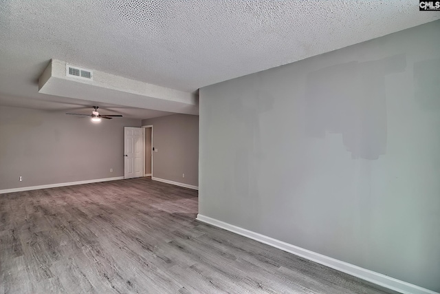 unfurnished room with ceiling fan, a textured ceiling, and light hardwood / wood-style flooring