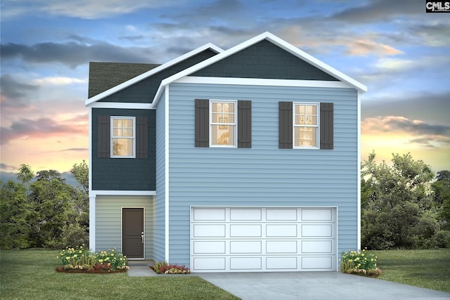 view of front facade with a yard and a garage