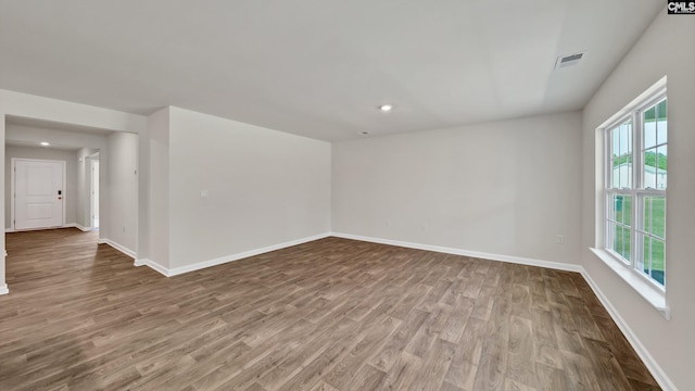 spare room with wood-type flooring