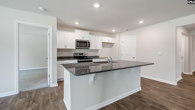 kitchen with a center island with sink, white cabinetry, sink, and appliances with stainless steel finishes