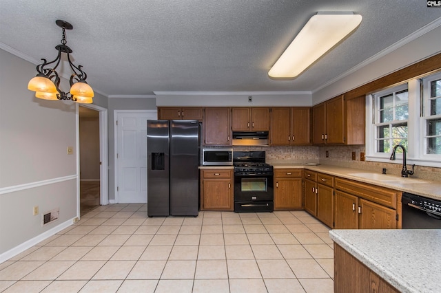 kitchen featuring black appliances, ornamental molding, decorative light fixtures, an inviting chandelier, and sink