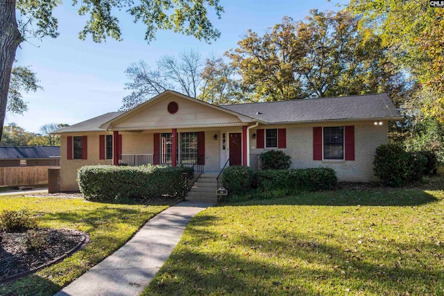 ranch-style house with covered porch and a front lawn